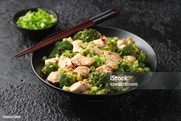 Stir Fried Chicken And Broccoli In Black Bowl Stock Photo - Download Image Now - Stir-Fried, Broccoli, Vegetable