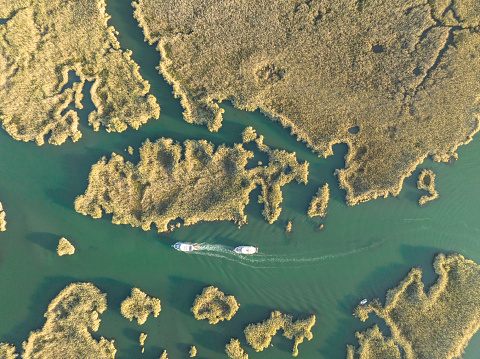 Daily tour boat on Dalyan delta in Muğla, Türkiye. Taken via drone.