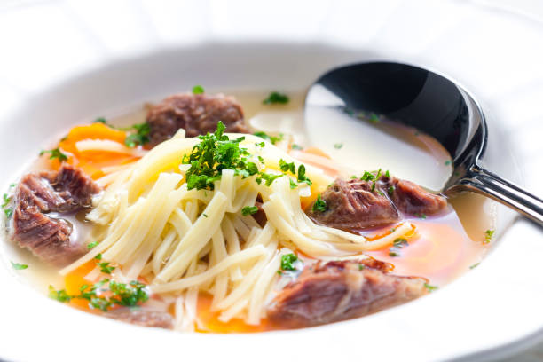 beef broth with noodles and carrot