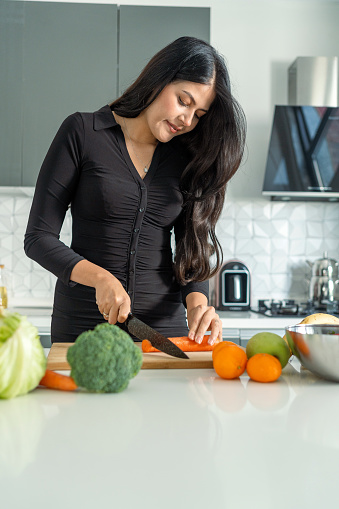 Woman on diet preparing healthy food in the kitchen