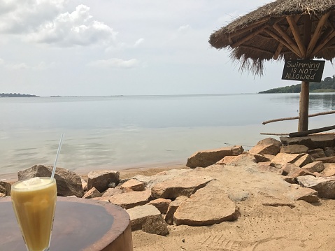 Shoreline of the lake in Entebbe with drink and sign