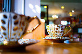 istock Cup of hot coffee with stream above on wooden desk with beautiful bokeh in cafe 1456554527