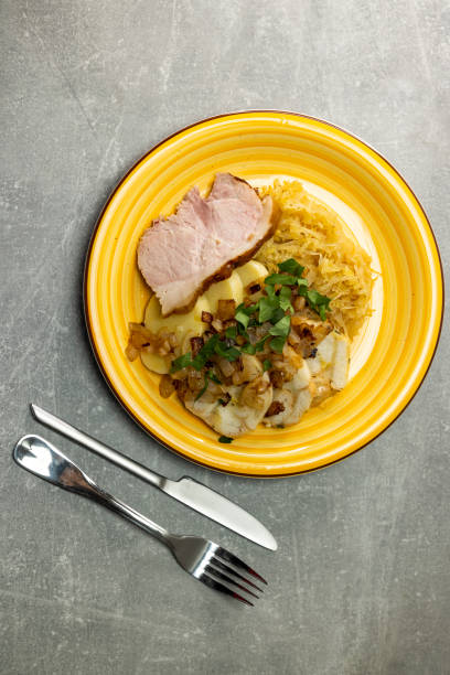 istock pork meat with potato dumplings and pickled cabbage served with roasted onion 1456556001