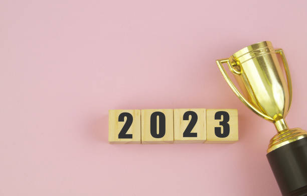 istock Gold trophy champion cup and numbers 2023 on pink background. 1456557640