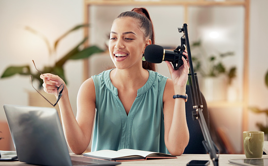Podcast, influencer and woman in home office with microphone and laptop, live streaming business and finance tips. Blog, speaker and girl recording or creating content for online social media page