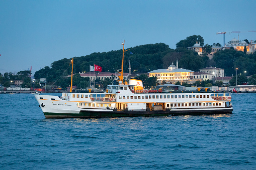 Istanbul, Turkey : Jun 13, 2019: Passenger ferry in the Bosphorus at sunset, Istanbul, Turkey