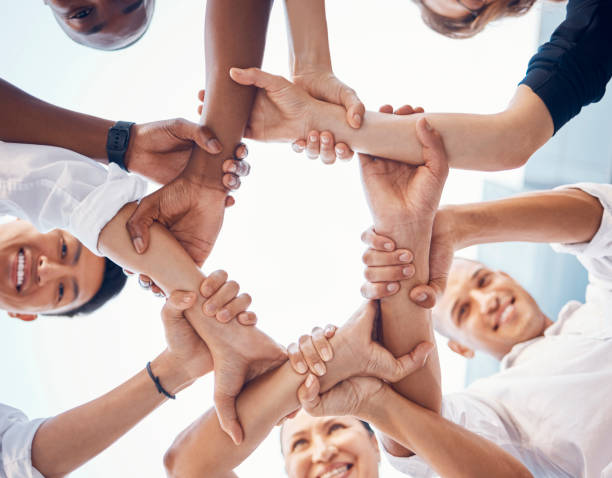istock Team, hands and employee support for team building motivation on mission goals. Diversity, business teamwork and holding hands for success or trust collaboration in corporate startup community 1456566654