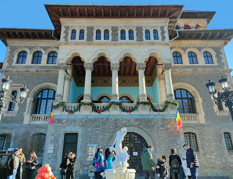 Busteni, Romania - December 31, 2022: The people near Cantacuzino Castle or Nevermore Academy - the place where the Wednesday series film was filmed