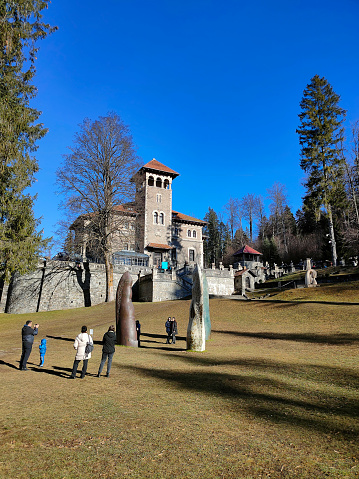 Busteni, Romania - December 31, 2022: The people going near Cantacuzino Castle or Nevermore Academy - the place where the Wednesday series film was filmed