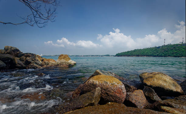 istock sea landscape with rocks in foreground under blue sky with distance mountain range 1456572084