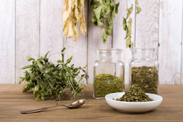 istock Herbal tea or dried herbs or medicine in jars with spoon 1456574938