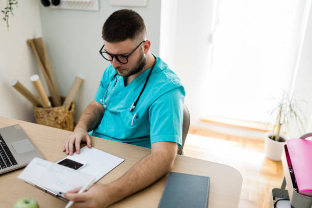 istock Young doctor working at his office 1456575294