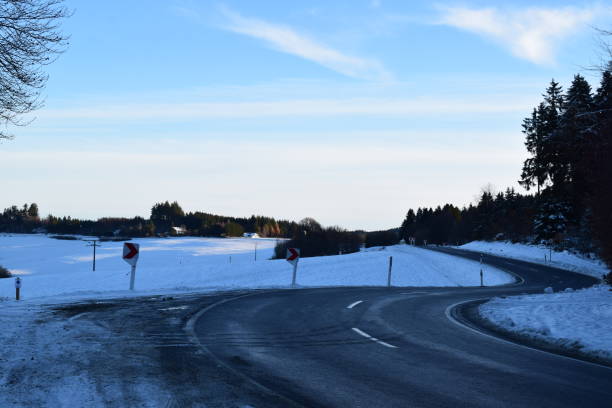 istock curvy mountain road with snow 1456576226