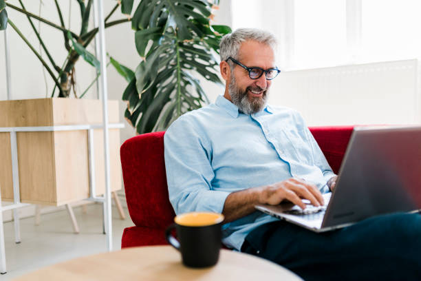 istock Man drinking coffee and having video call at home office 1456576296