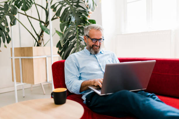 istock Man drinking coffee and having video call at home office 1456576317