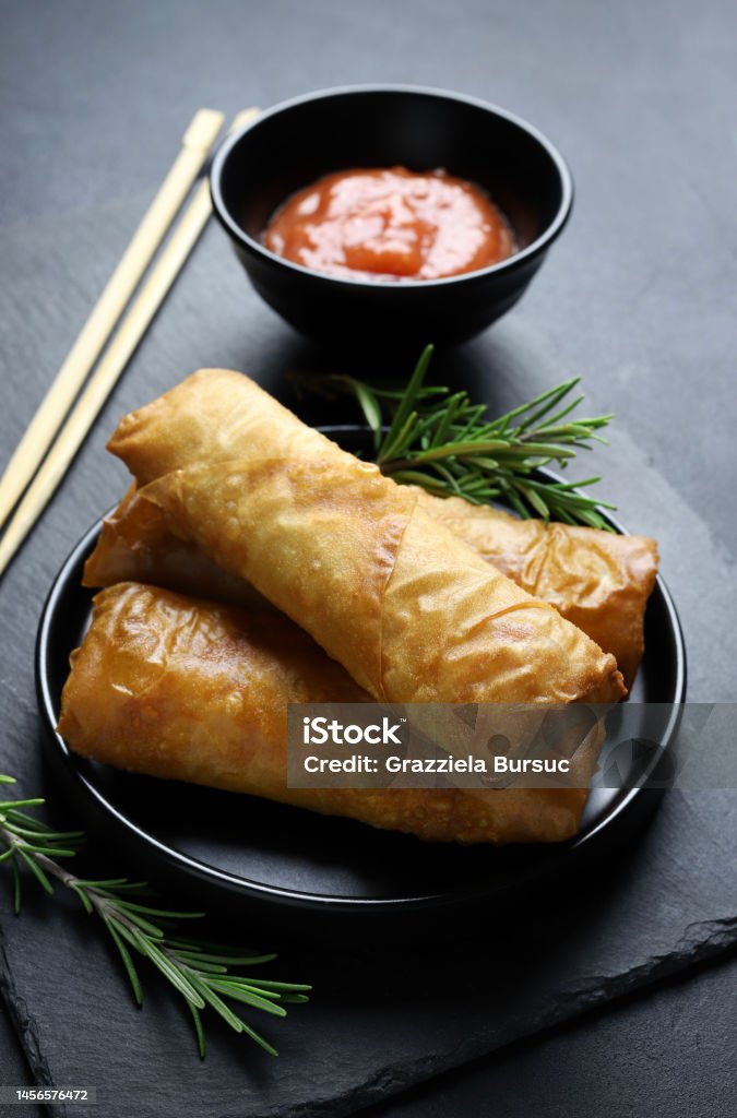 Fried spring rolls. Fried spring rolls with sweet chili sauce on dark background. Asian cuisine. Appetizer Stock Photo