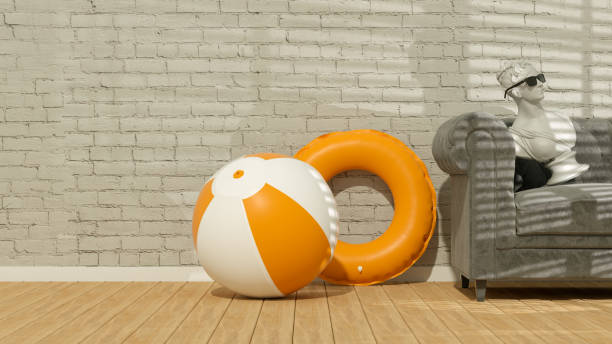 istock Beach Ball and Inflatable Ring in Room with Empty Brick Wall and Sunlight, Summer Background 1456576627