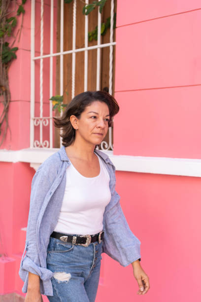 istock Trendy young woman walking on street 1456576745