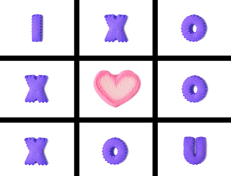 Vibrant Colored Typography of I LOVE U in Tic Tac Toe Game made with alphabet shaped cookies and heart shaped marshmallow on white background