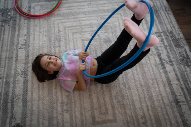 istock Little girl playing with hula hoop 1456579642