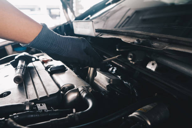 istock Mechanical man hand checking and change ignition coil with spark plug of car engine 1456580264