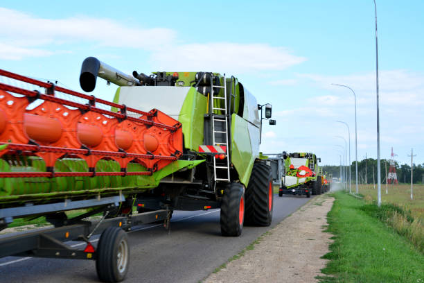 istock combine harvesters going forward on the road in a row, close-up 1456581176