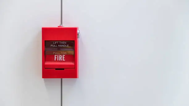 Fire alarm on the wall. Emergency of Fire alarm or alert or bell warning equipment. Fire alarm box on cement wall for warning and security system in the condominium place.