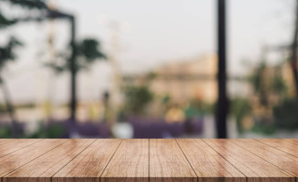 istock Empty wooden table top with lights bokeh on blur restaurant background. 1456584418