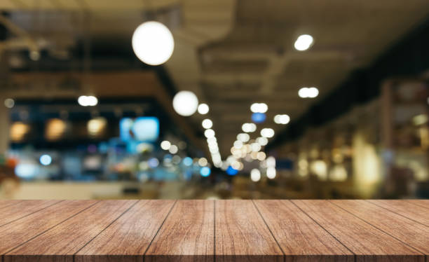 istock Empty wooden table top with lights bokeh on blur restaurant background. 1456584419