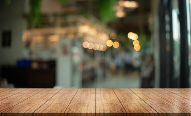 istock Empty wooden table top with lights bokeh on blur restaurant background. 1456584425