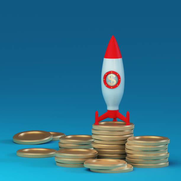 istock Rocket is set to launch on columns of metal coins on a blue background. Place for text and logo. Financial concept. Starting a business. 3D rendering 1456585049