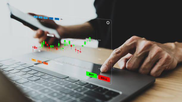istock Businessperson, investor using laptop for trading. Trader data and information analysis chart for planning in strategy of stock market money or fund. Business financial concept of growth and success 1456585054