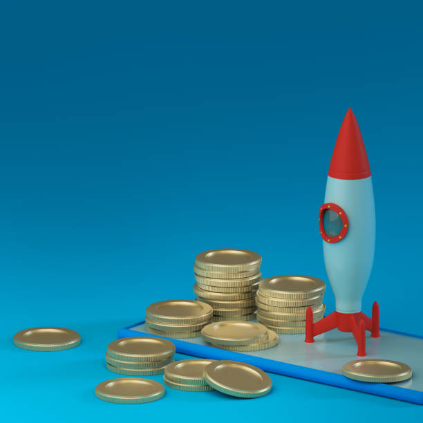 istock Rocket set to launch on a smartphone with columns of metallic coins on a blue background. Place for text and logo. Financial concept. Starting a business. 3D rendering 1456585126