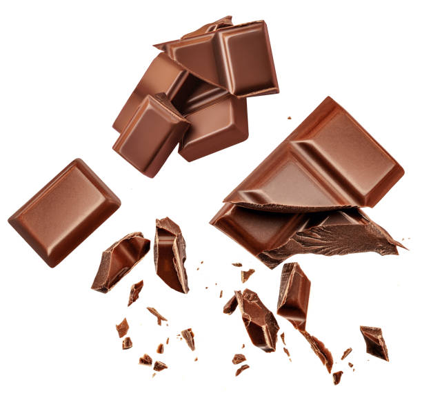 istock Dark chocolate chunks isolated on white background. Collection. Flying Chocolate pieces, shavings and cocoa crumbs Top view. Flat lay. Pattern 1456585427