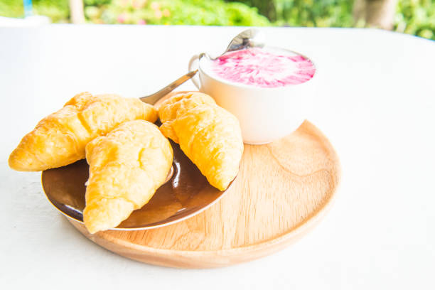 Hot fresh milk with fresh croissants on white table, Thailand