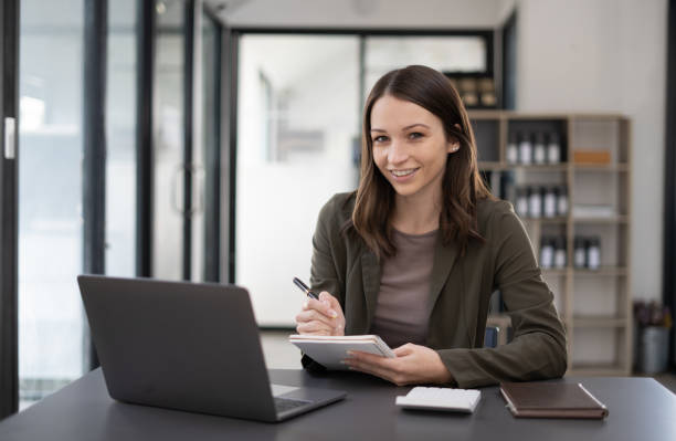 istock Beautiful woman at the modern office with a computer laptop. 1456586701