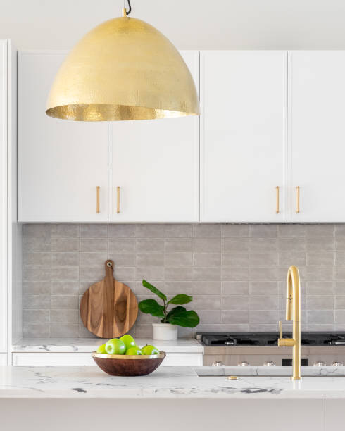 istock A white kitchen detail with gold light and faucet. 1456587172