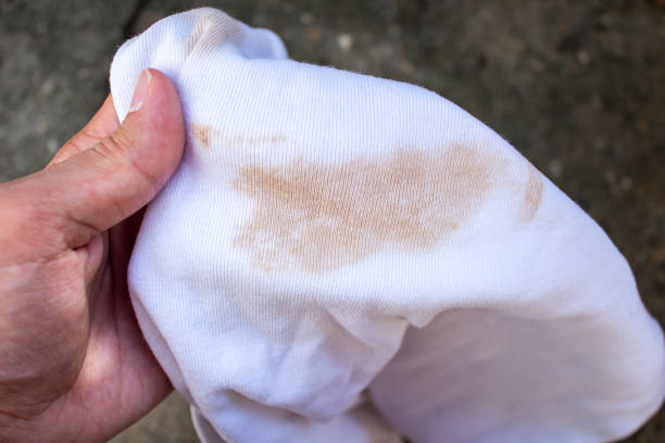 istock Hand holding dirty t shirt 1456591597