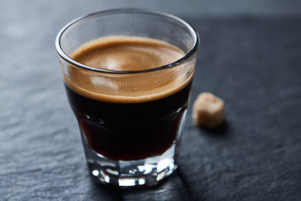 istock Coffee in glass cup on dark stone background. Close up. 1456591911