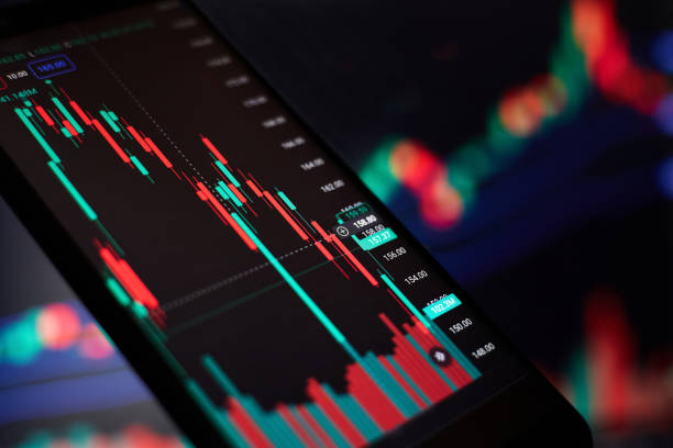 istock Stock market graph and Volume indicator in a smartphone against the blurred background of graphs on the monitor 1456593216