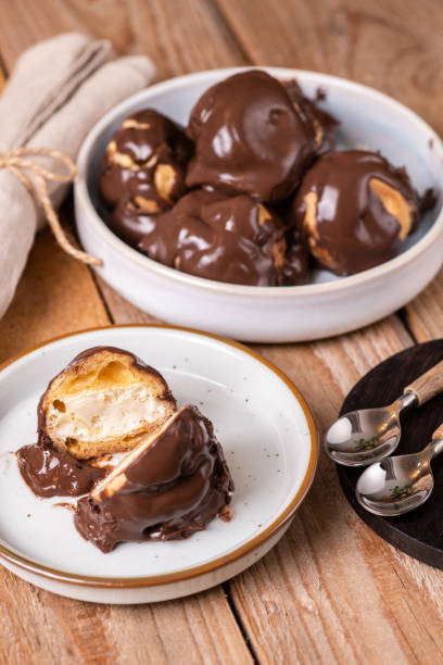 Italian dessert profiteroles with vanilla cream and chocolate cream