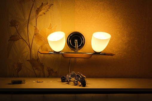 Night lamp with two lamps on the wall in the room. High quality photo