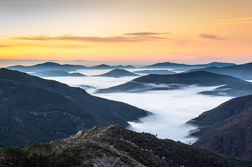 Idyllic sunrise with sea of clouds in the mountains