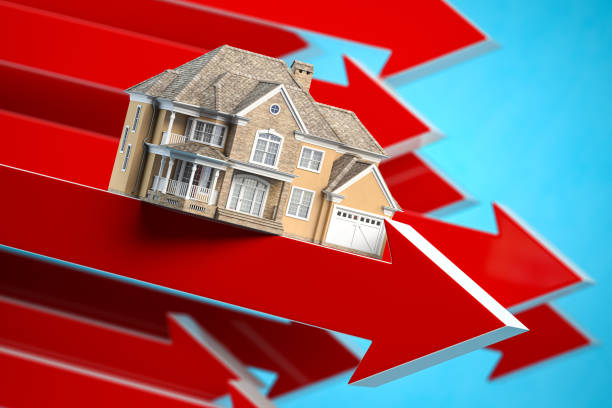 Real Estate market crisis. Home value and rent housing prices decreasing concept. House on a falling arrow. stock photo