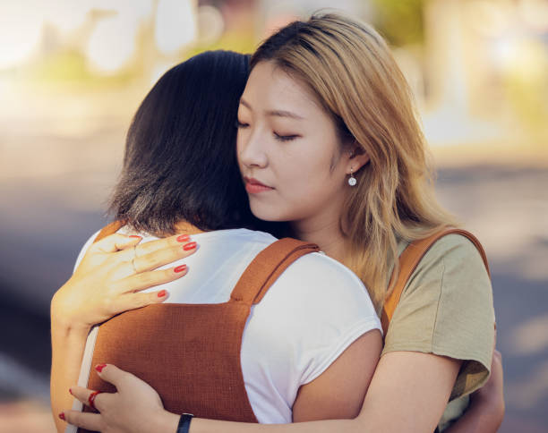 istock Love, women and hug for connect, sad and support for understanding with problem, compassion and calm together. Asian woman, girl and embrace friend, loving and help to console in kind relationship 1456596956