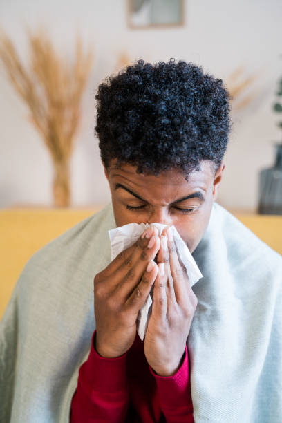 istock African American boy with cold and wiping his nose 1456601316