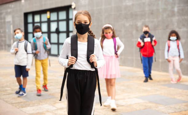 istock Tweenager girl in protective mask going to school lessons 1456603328