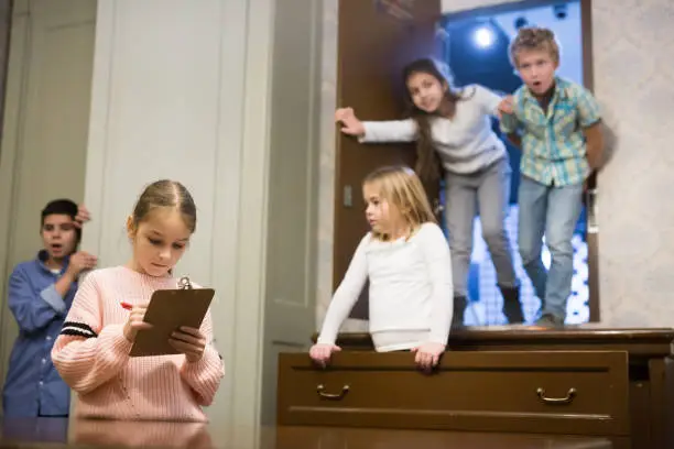 Photo of Tween girl solving conundrum to get out of escape room