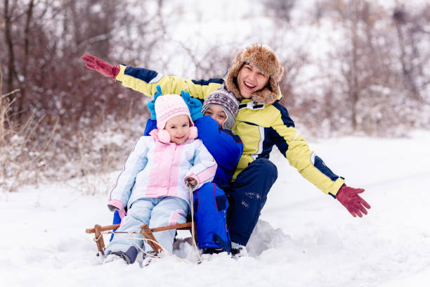 istock Family sledging on the snow 1456605052