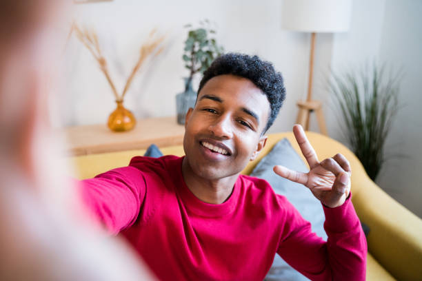 istock Cheerful black man doing a selfie and showing thumbs up 1456605152